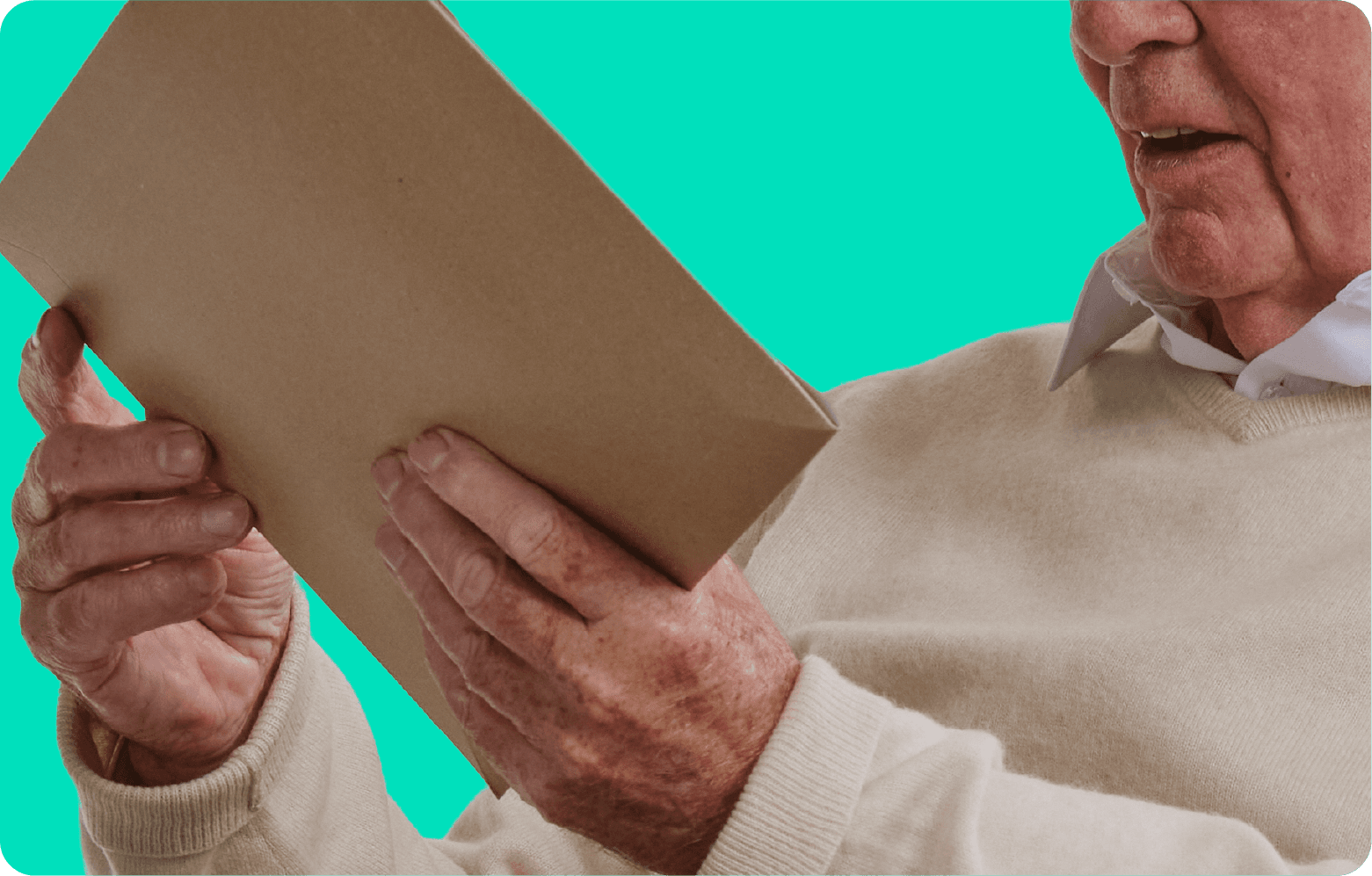 An elderly person in a beige sweater holding and looking at a brown paper envelope against a bright turquoise background.
