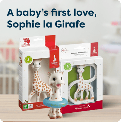 Sophie la Girafe at Pharmacy2U. Boxes of Sophie la Girafe baby teethers and a Sophie giraffe toy with a blue ring around its neck displayed on a wooden surface.