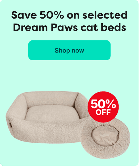 Advertisement for Dream Paws cat beds with a 50% discount. Features two cream-colored cat beds and a "Shop now" button.
