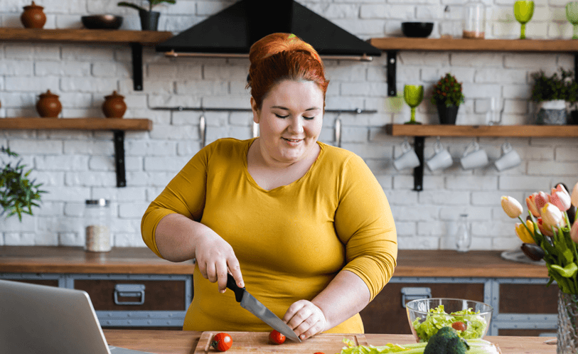 Woman in the kitchen cutting healthy food