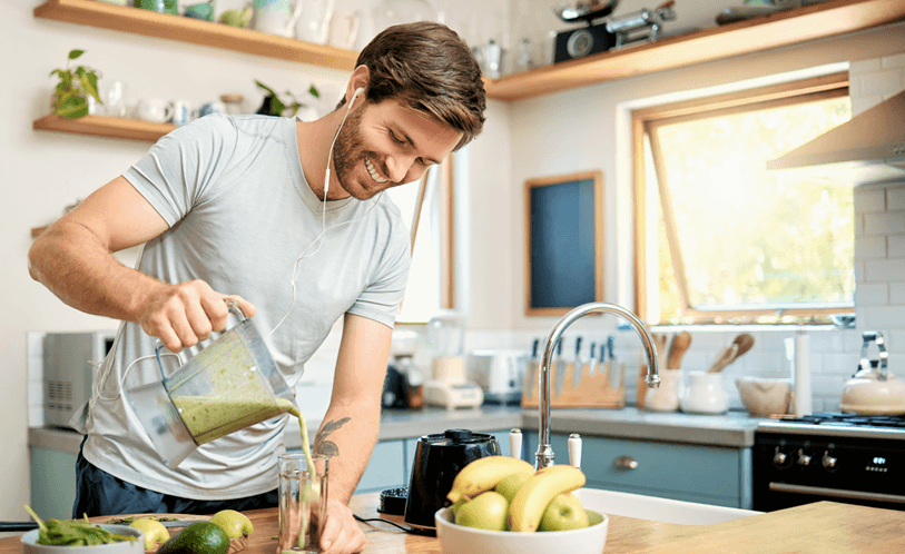 Man making a smoothie in the kitchen