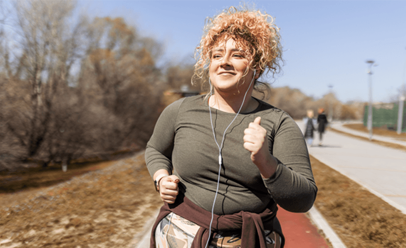 Woman running outside in the sun