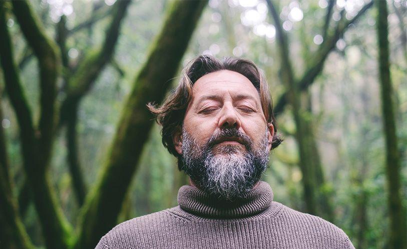 anxiety image, man walking and relaxing in nature