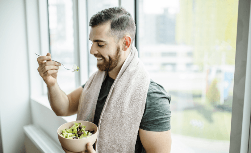 Man eating a bowl of salad