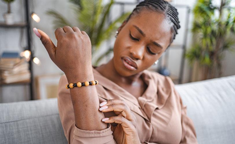 eczema image, woman looking down at her arm